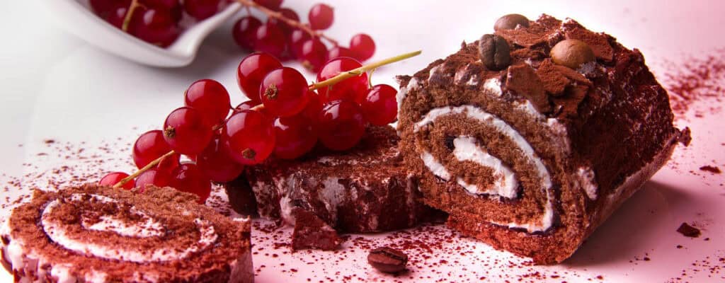 Chocolate Swiss roll cake with red currants