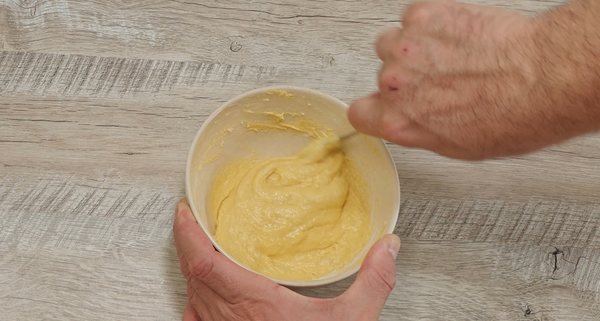 Soft egg and flour dumpling dough being mixed in a bowl